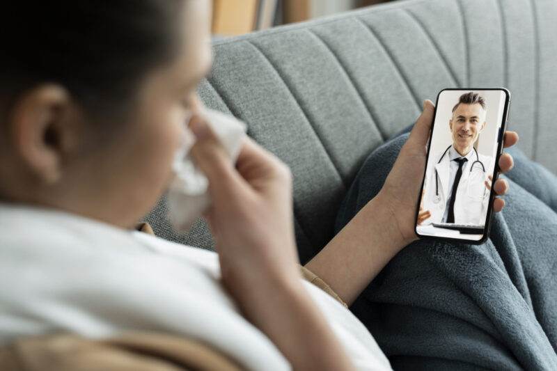 A worried patient using online doctors for a medical consultation, illustrating telehealth risks.