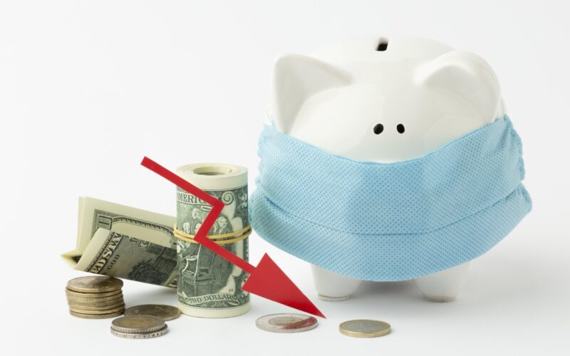 Influenza - Piggy bank wearing a medical mask with a red downward arrow pointing toward currency.
